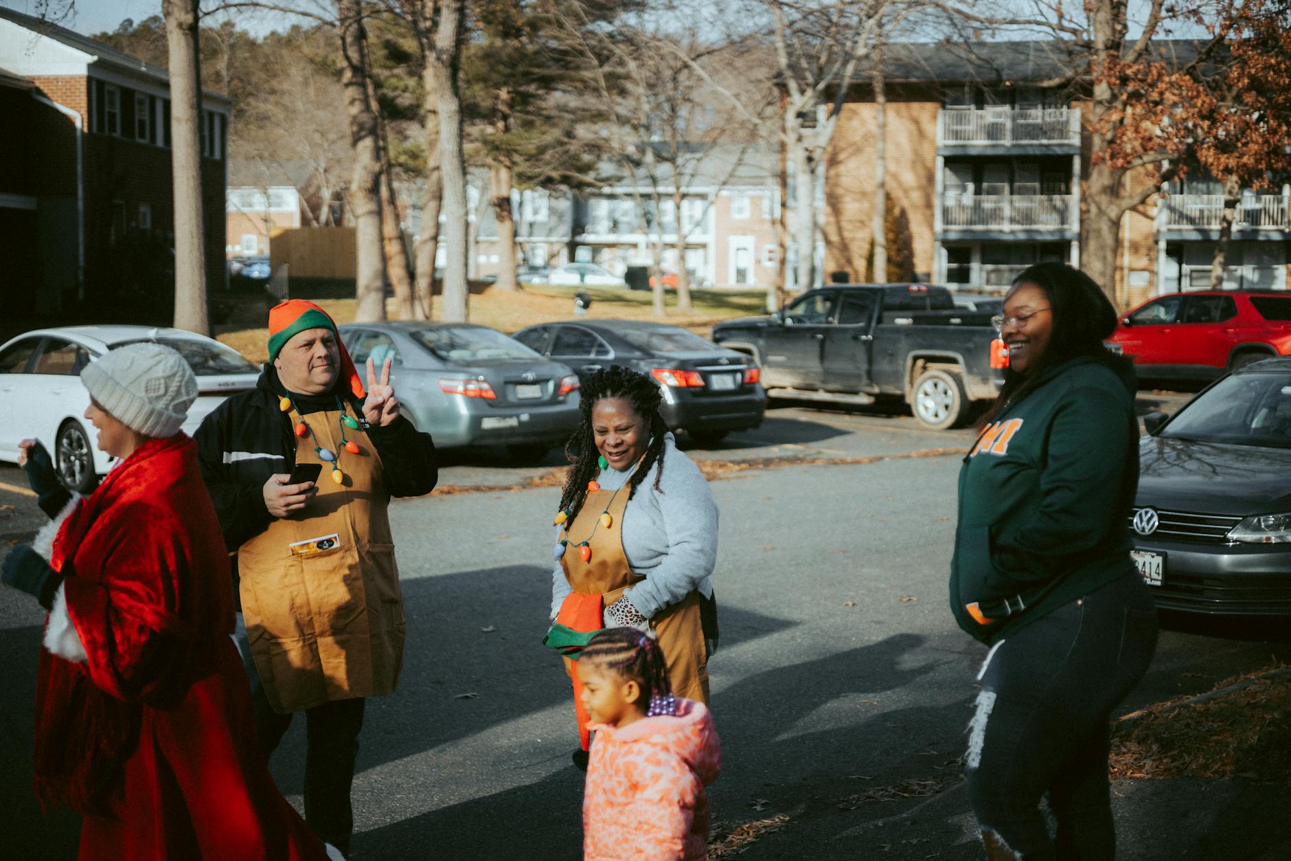 A diverse group of adults and children enjoying a festive community event outdoors.